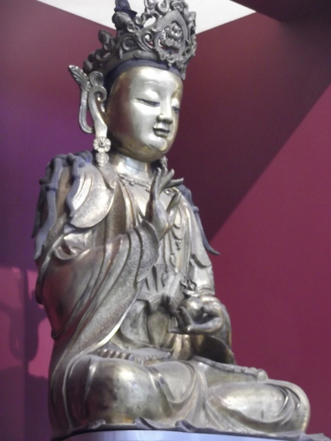 Huge Buddha sitting, right hand raised, eyes closed