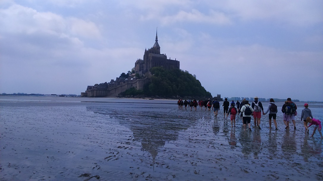 walking across the sands to mont saint michel