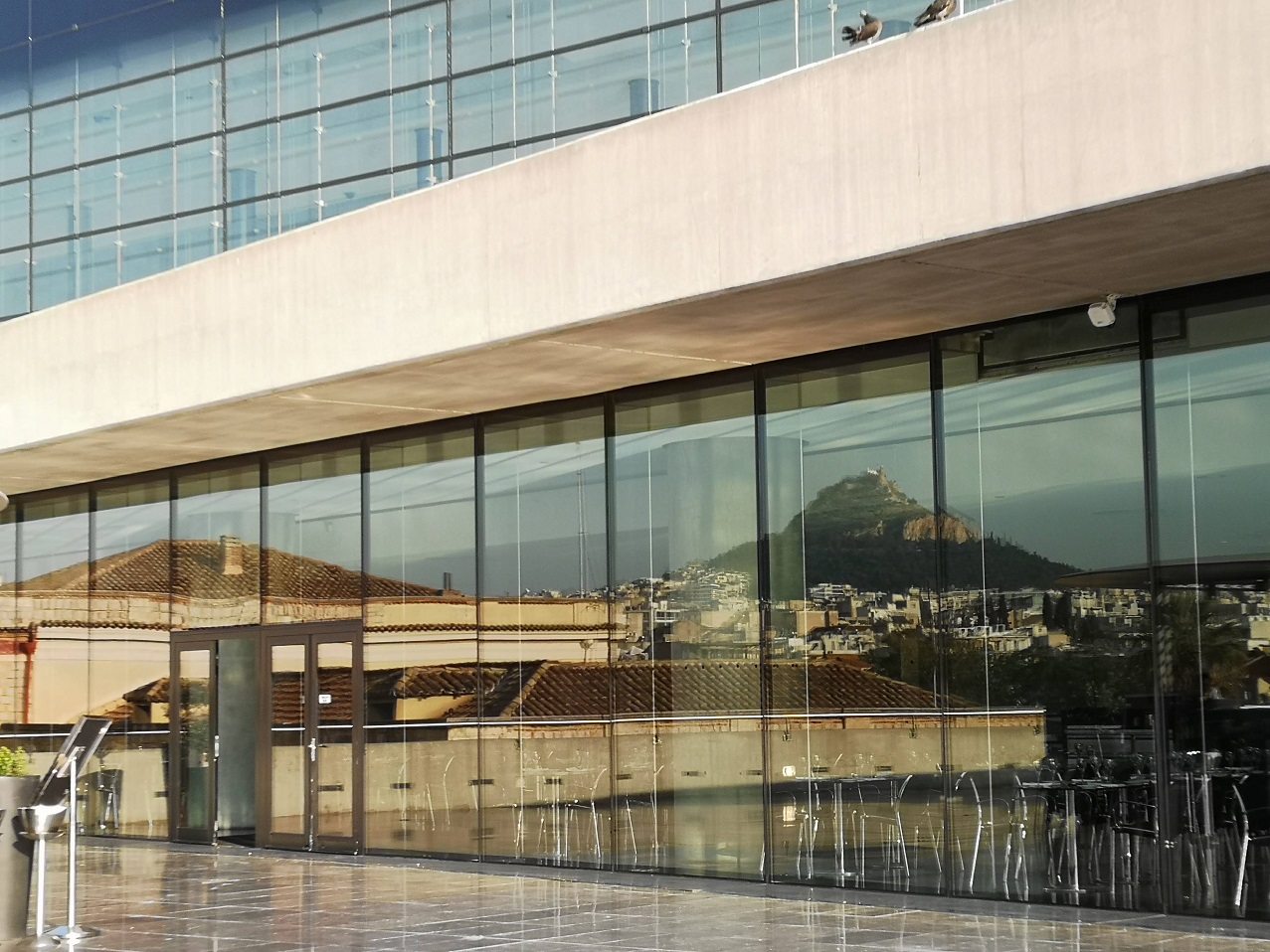 Glass doors with mountain reflected in them
