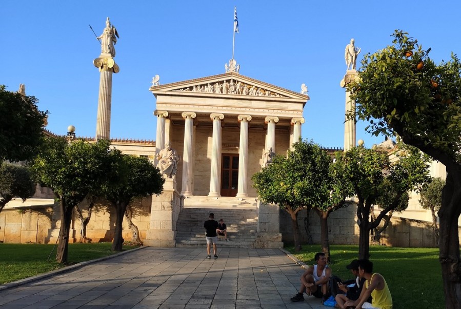 Classical Greek architecture with colums, pillars, statues and Greek flag flying