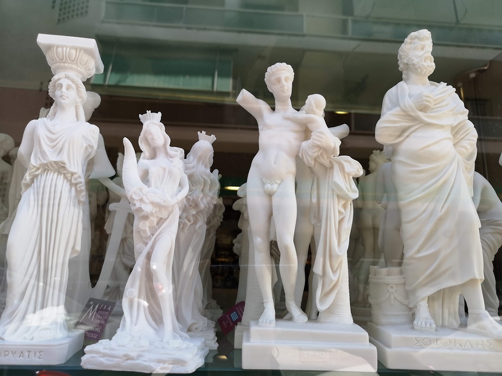 Naked male figure and clothed goddesses