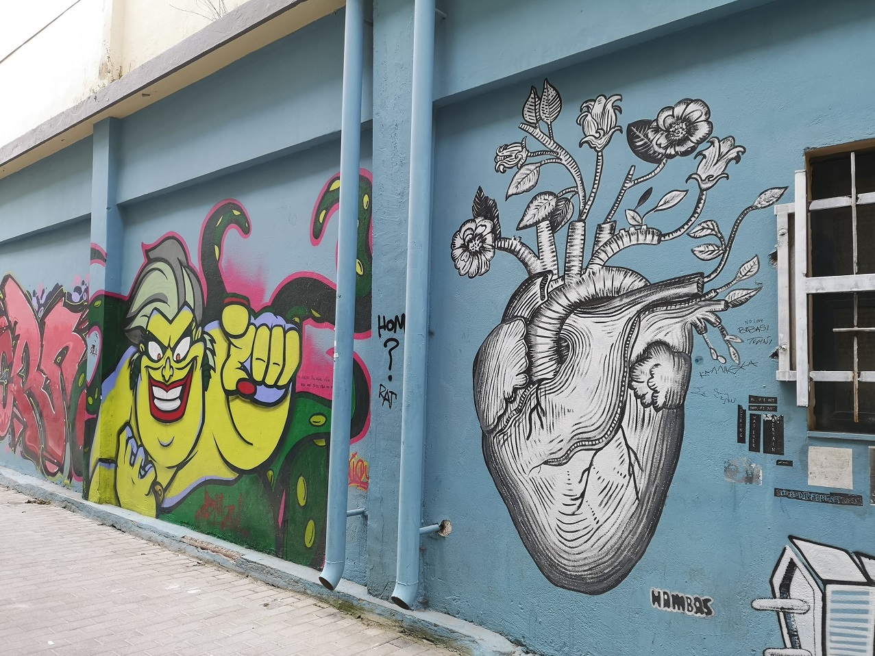 Line drawing of a heart with flowers on wall