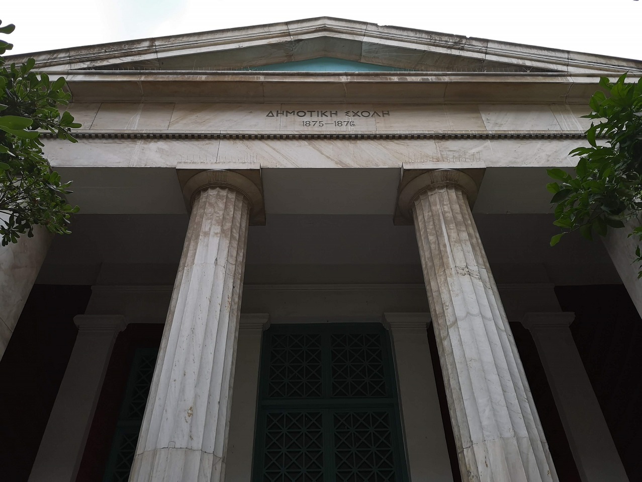 Classical Greek facade of school with columns and triangular roof, Athens