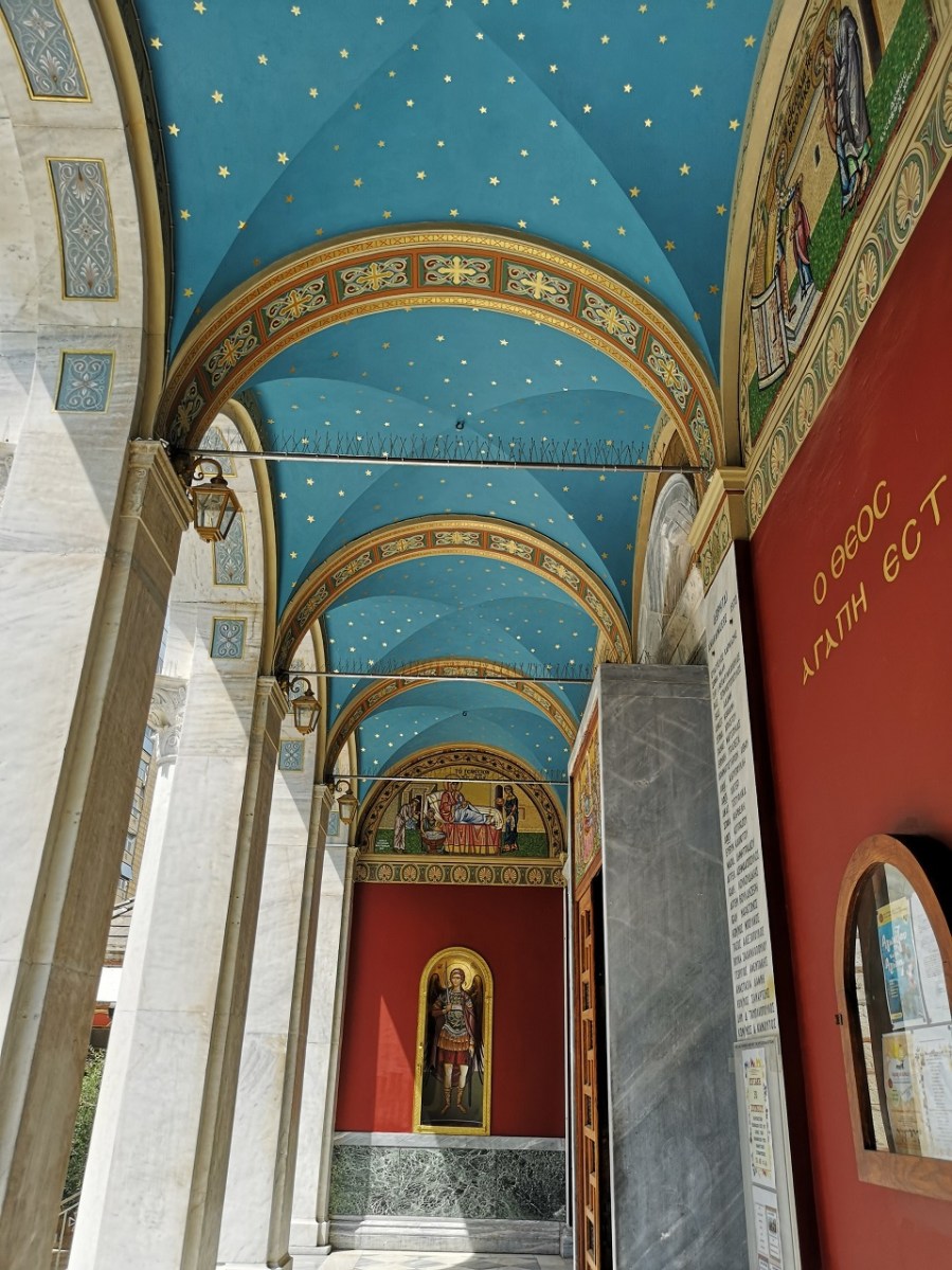 Blue painted roof with golden stars and red walls with religious paintings