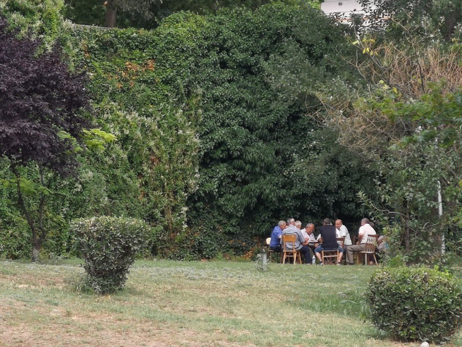 10 men sit around a table 