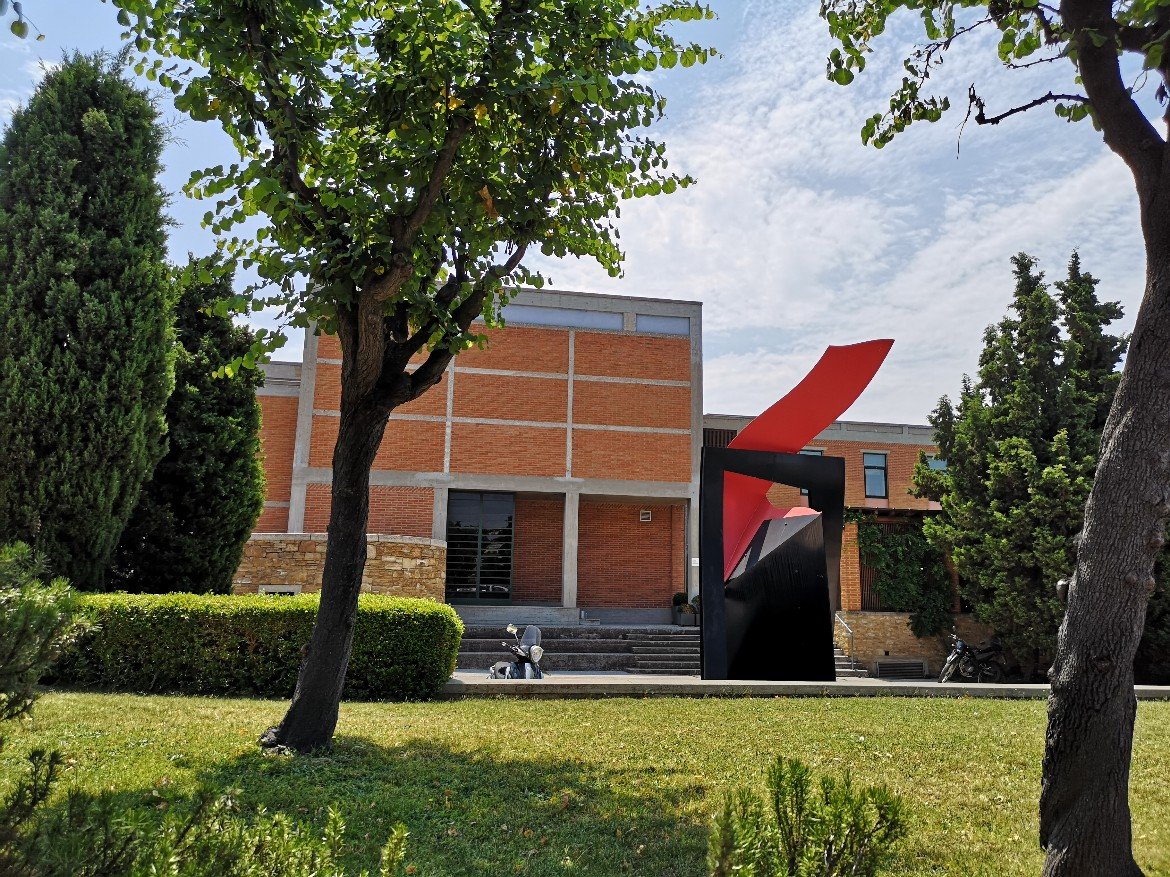 Red sculpture in front of building 