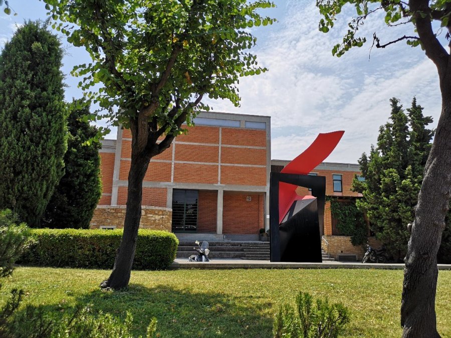 Red sculpture in front of building 
