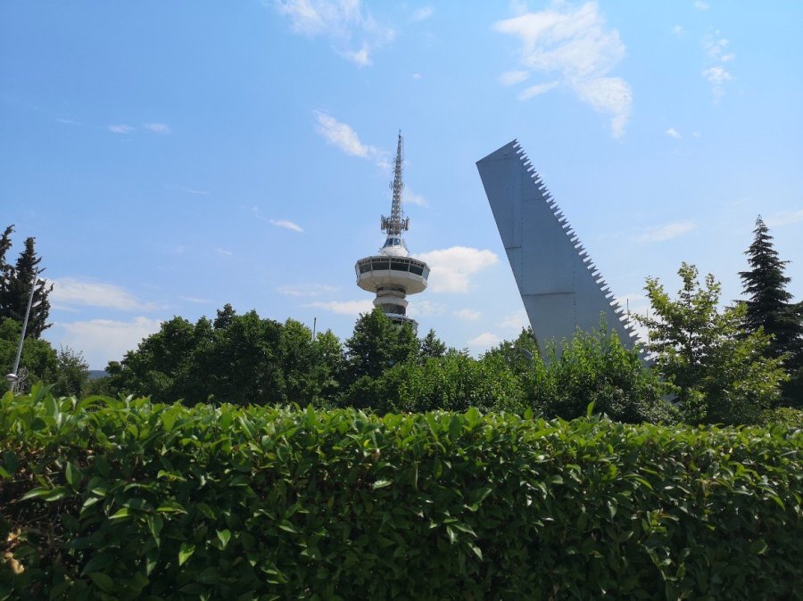 A round tower and a metal serrated monument 