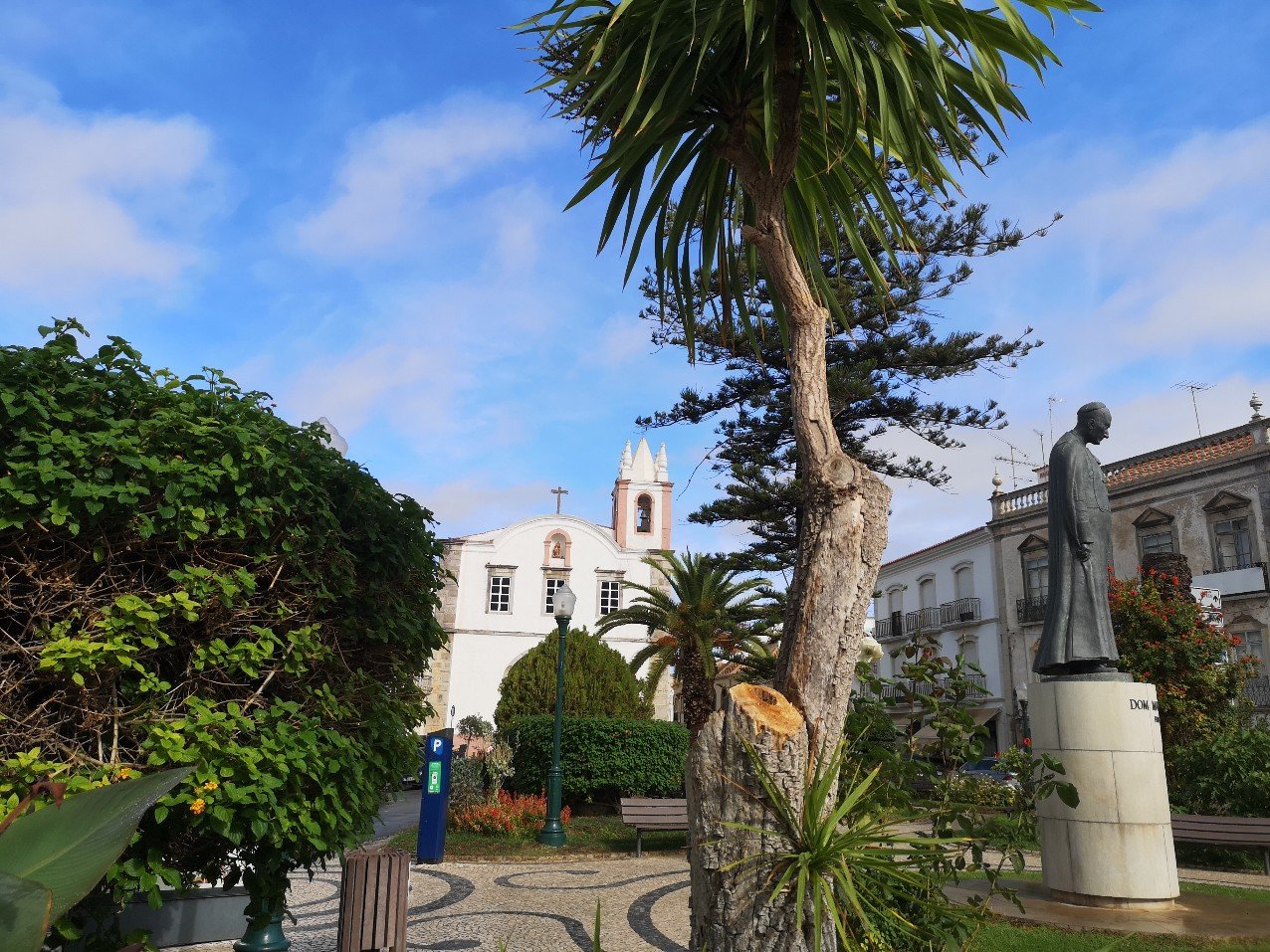Church of our Lafy of Learning or Saint Paul, in leafy square with statue, Tavira, Portugal