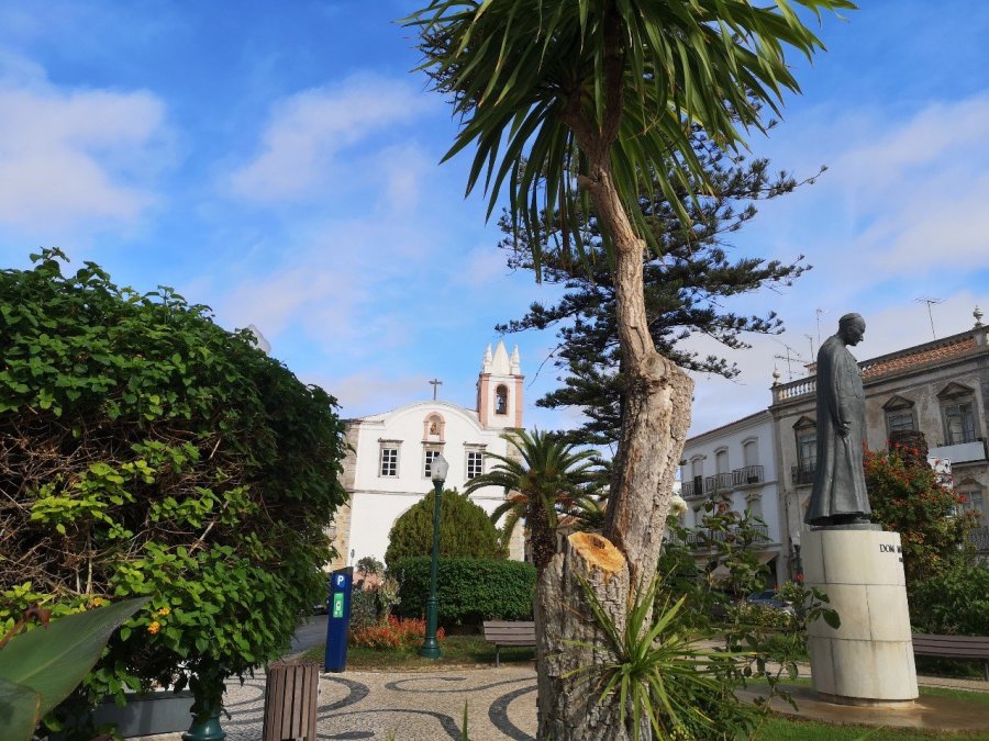 Church of our Lafy of Learning or Saint Paul, in leafy square with statue, Tavira, Portugal